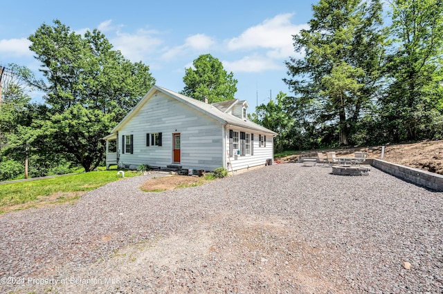 view of side of home featuring a fire pit