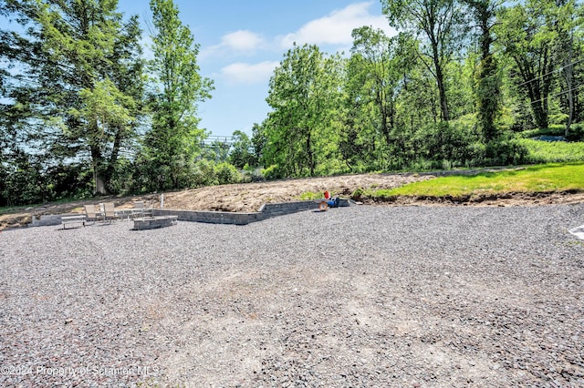 view of yard with a fire pit