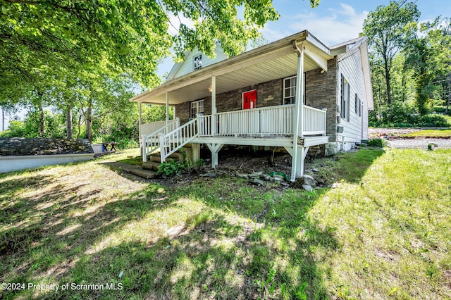 view of home's exterior with a lawn and a porch