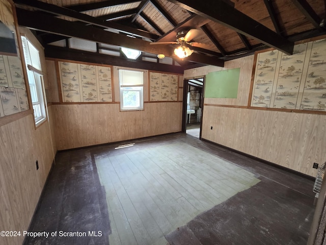 spare room featuring lofted ceiling with beams, ceiling fan, dark wood-type flooring, and wood ceiling