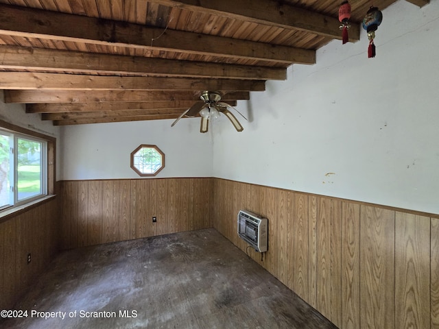 spare room featuring heating unit, wooden walls, wood ceiling, and vaulted ceiling with beams