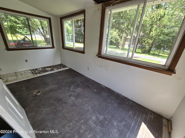 unfurnished sunroom featuring a healthy amount of sunlight and lofted ceiling