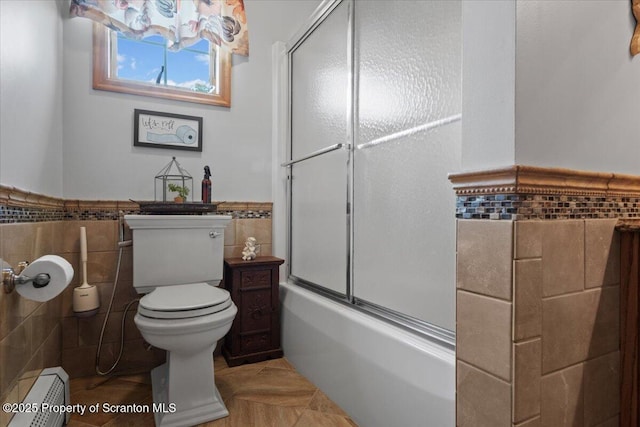 2748 Pennay Hill Rd, Kingsley, PA 18826 - full bath with tile walls, a baseboard radiator, a wainscoted wall, shower / bath combination with glass door, and tile patterned floors
