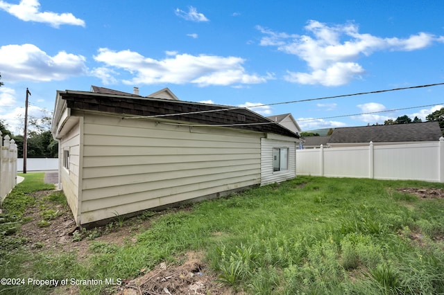 view of home's exterior with a yard