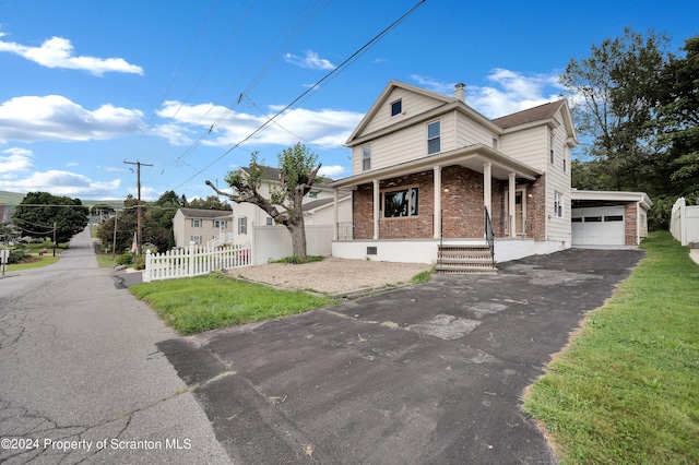 view of front facade featuring a front lawn, a porch, and a garage