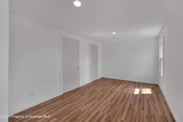 unfurnished room with light hardwood / wood-style floors