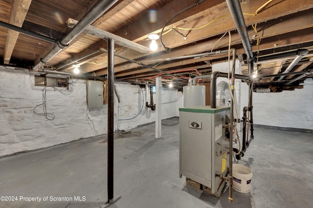 basement featuring electric panel and water heater