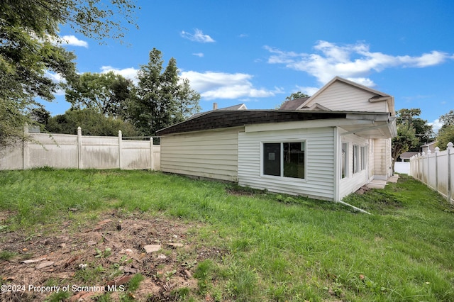 view of side of property with a lawn