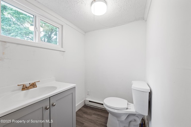 121 Throop St, Scranton, PA 18508 - half bathroom with a baseboard heating unit, a textured ceiling, toilet, vanity, and wood finished floors