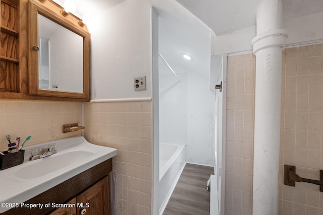 121 Throop St, Scranton, PA 18508 - bathroom featuring tile walls, vanity, a bath, wood finished floors, and a shower