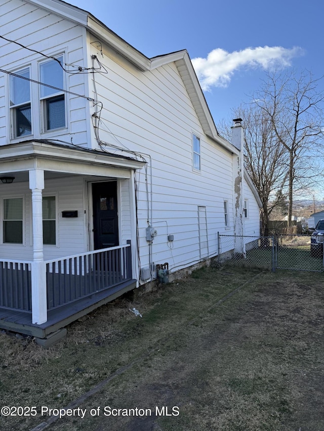 121 Throop St, Scranton, PA 18508 - view of side of property with fence, a chimney, and a porch