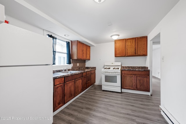 121 Throop St, Scranton, PA 18508 - kitchen featuring white appliances, a baseboard heating unit, dark countertops, and wood finished floors