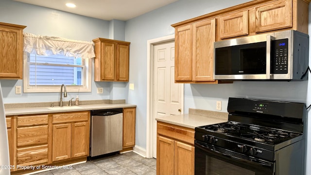 kitchen with sink and appliances with stainless steel finishes