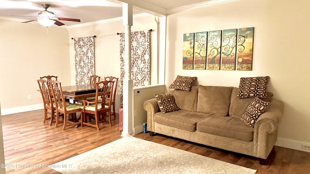 living room with crown molding, ceiling fan, and hardwood / wood-style flooring