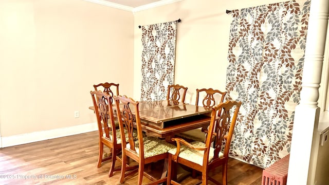 dining area with ornamental molding and wood-type flooring