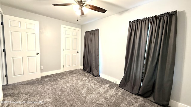 unfurnished bedroom with ceiling fan and carpet flooring