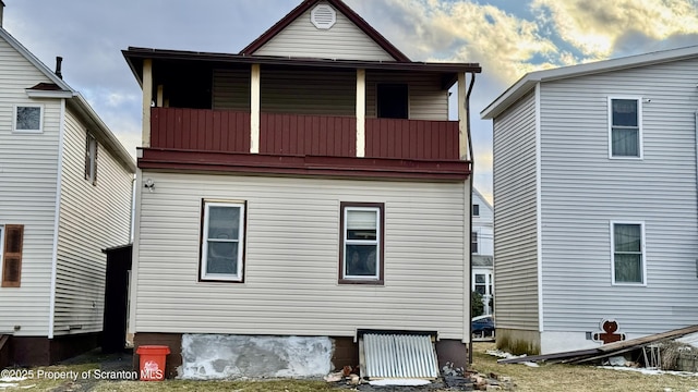 rear view of property with a balcony