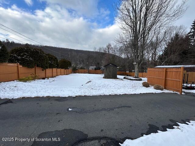 view of yard layered in snow