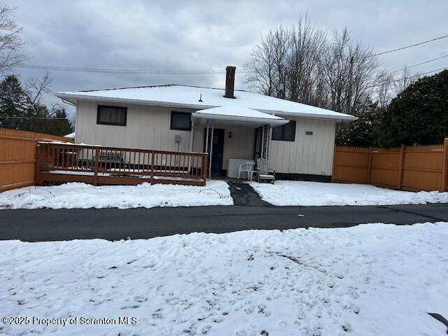 view of snow covered rear of property