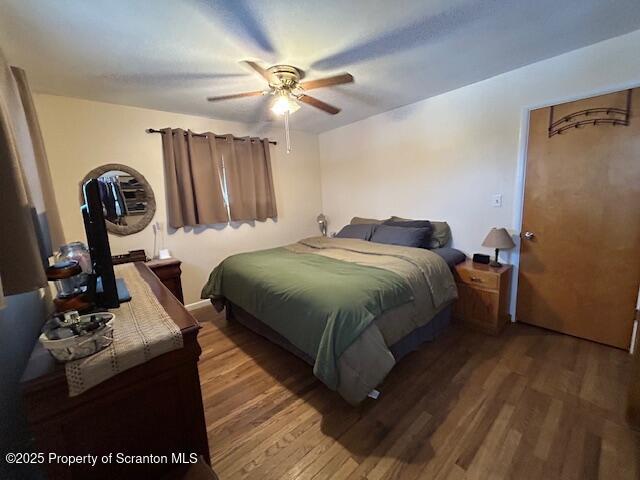 bedroom featuring hardwood / wood-style flooring and ceiling fan