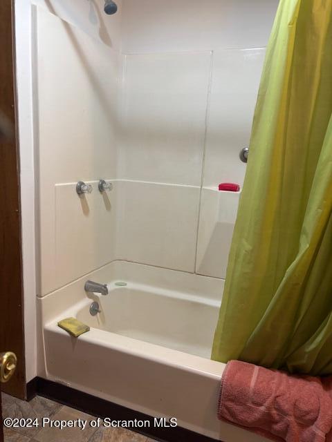 bathroom featuring tile patterned floors and shower / tub combo