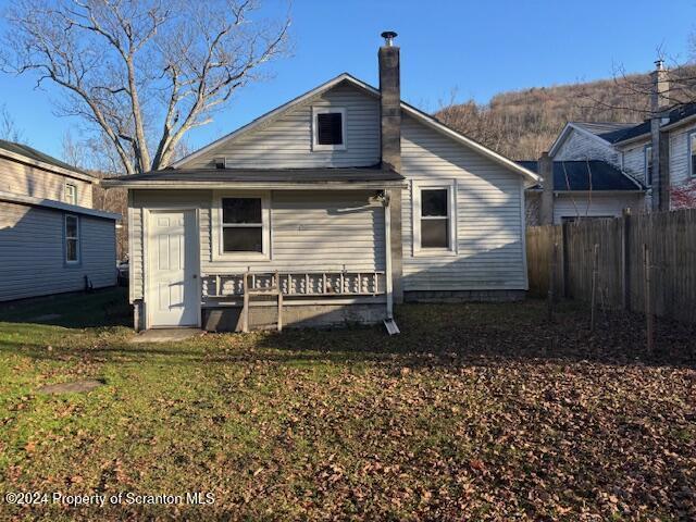 rear view of house with a yard