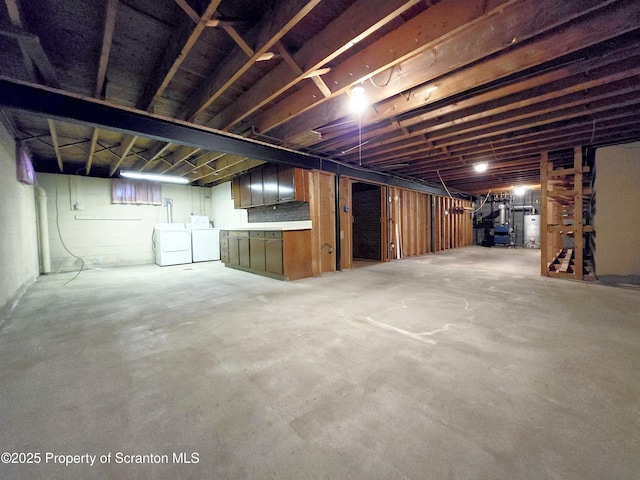basement with water heater and washing machine and clothes dryer