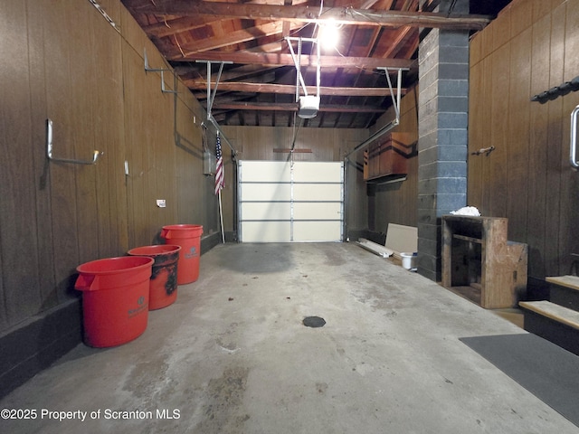 garage featuring wood walls and a garage door opener