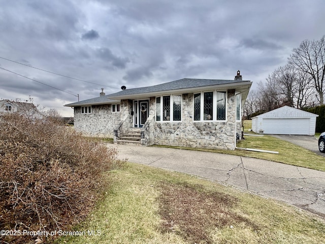 view of front of home featuring a garage, stone siding, a chimney, and an outbuilding