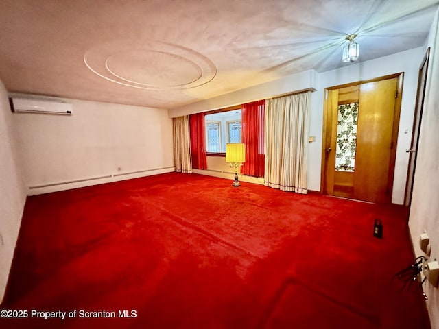 spare room featuring an AC wall unit and baseboard heating