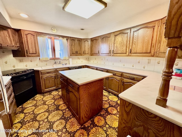 kitchen featuring a center island, tasteful backsplash, light countertops, black electric range oven, and brown cabinetry