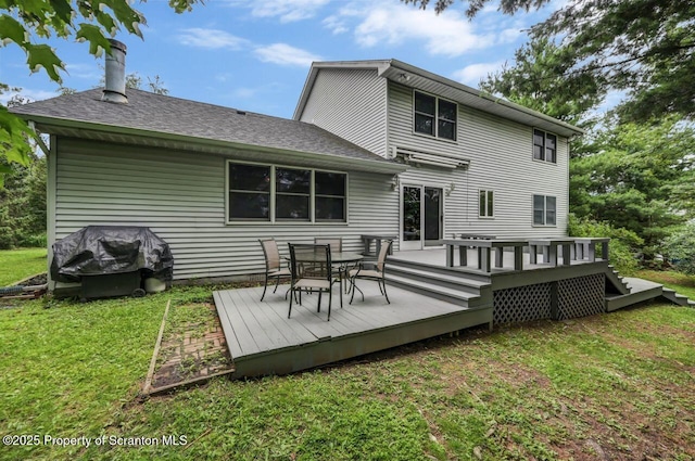 607 Pamela Dr, South Abington Twp, PA 18411 - rear view of property featuring a yard, a wooden deck, outdoor dining space, a chimney, and a shingled roof