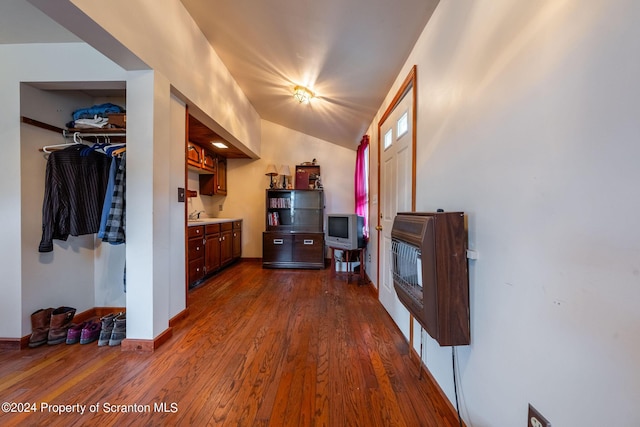 bonus room with heating unit, dark hardwood / wood-style flooring, and lofted ceiling