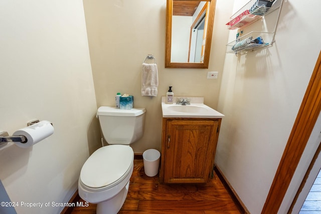 bathroom featuring vanity, wood-type flooring, and toilet