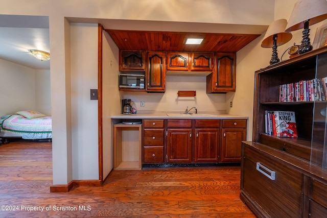 kitchen featuring dark hardwood / wood-style flooring, sink, and wooden ceiling