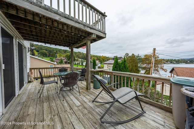 wooden terrace featuring a water view