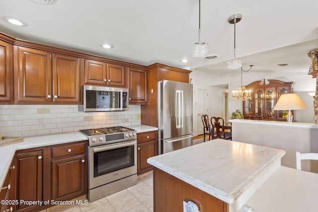 kitchen featuring stainless steel appliances, visible vents, and brown cabinetry