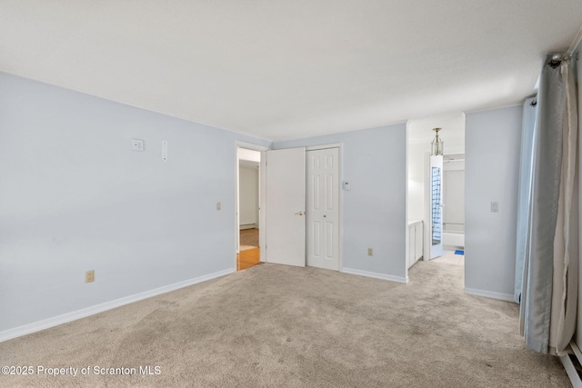 empty room featuring carpet flooring and baseboards