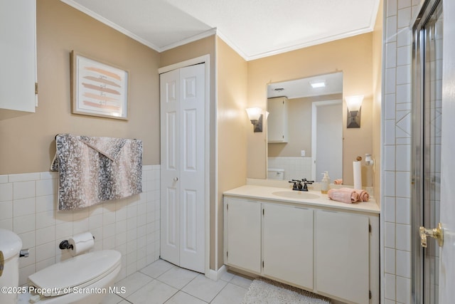 full bath with crown molding, tile walls, toilet, tile patterned floors, and vanity