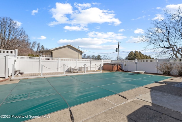 view of pool featuring a patio, a fenced in pool, a fenced backyard, a diving board, and a hot tub