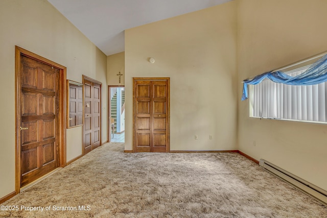 1300 Dundaff St, Dickson City, PA 18519 - unfurnished bedroom with baseboard heating, carpet flooring, high vaulted ceiling, and multiple windows
