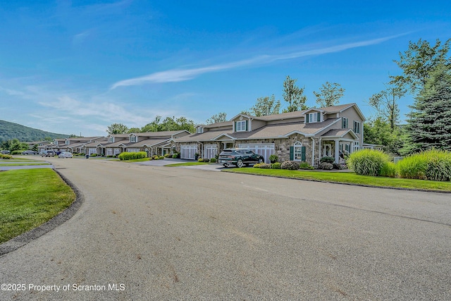 129 Wyndham Rd, South Abington Twp, PA 18411 - view of front of home featuring stone siding, a residential view, and a front lawn