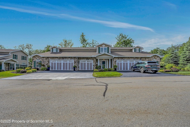 129 Wyndham Rd, South Abington Twp, PA 18411 - view of front of house with driveway, stone siding, and a garage