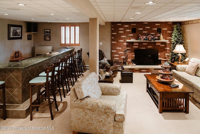 bar with a fireplace and a drop ceiling