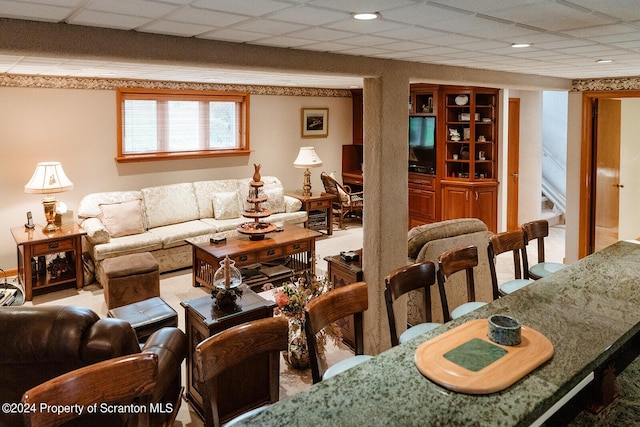 living room with a paneled ceiling