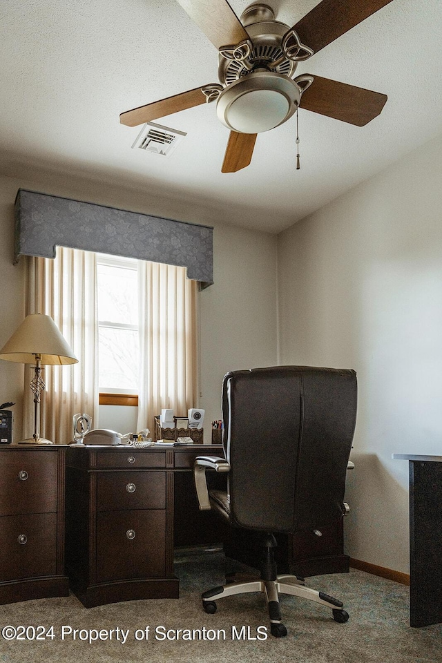 carpeted office featuring ceiling fan