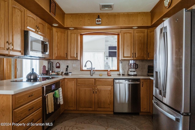 kitchen featuring kitchen peninsula, decorative backsplash, light tile patterned floors, and stainless steel appliances