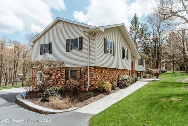 view of home's exterior with a lawn