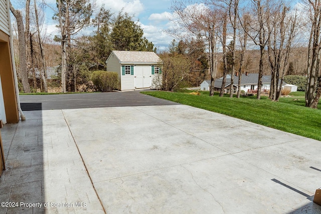 view of patio featuring a shed