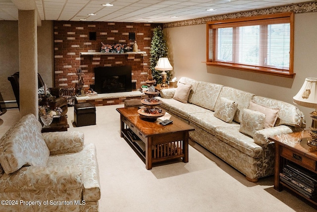 carpeted living room with a fireplace and a paneled ceiling